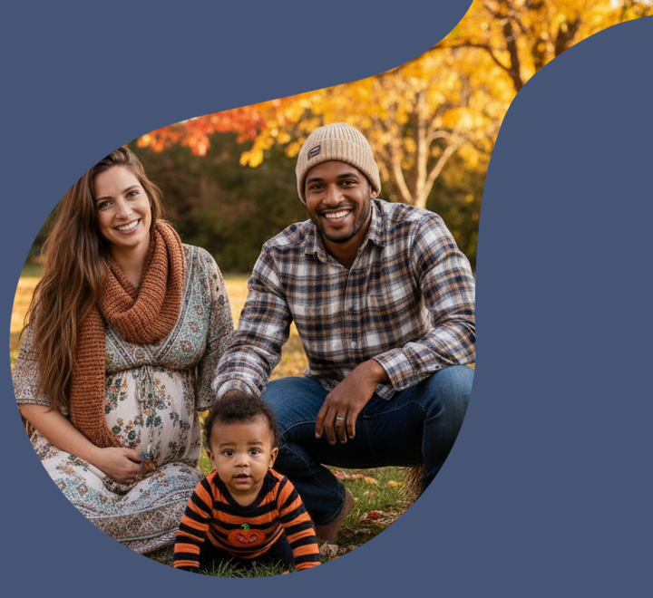 Young expecting couple pozing with their toddler fall pumpkin patch